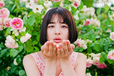 Woman putting flower on her palm Stock Photo - Premium Royalty-Free, Code: 669-08637485