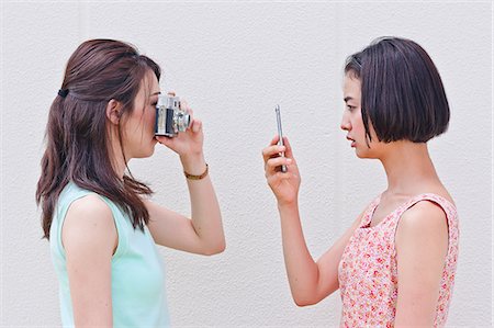 shot - Women taking a picture each other Stock Photo - Premium Royalty-Free, Code: 669-08637480
