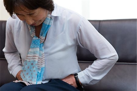 A senior woman suffering from a stomachache Stock Photo - Premium Royalty-Free, Code: 669-08914534
