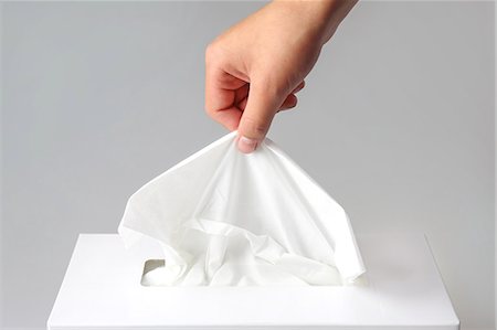A hand seizing tissue Stock Photo - Premium Royalty-Free, Code: 669-08914651
