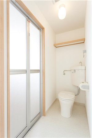 Little girl next to children's toilet with panties around ankles