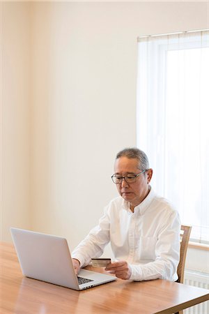Senior man using laptop Stock Photo - Premium Royalty-Free, Code: 669-09145686