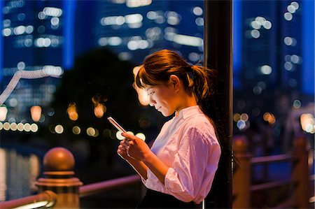 smart phone - Woman with Mobile in Night City Stock Photo - Premium Royalty-Free, Code: 669-09158294
