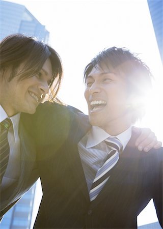 Businessmen with arms around shoulder Stock Photo - Premium Royalty-Free, Code: 669-02309188