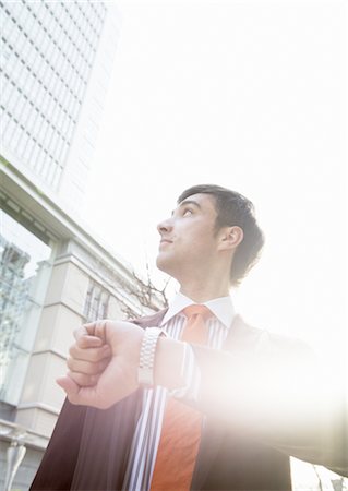 financial district - Businessman looking up Stock Photo - Premium Royalty-Free, Code: 669-02966073