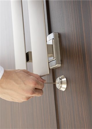 Close up of hand locking door Stock Photo - Premium Royalty-Free, Code: 669-03707978