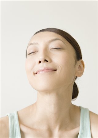 A woman closing her eyes Stock Photo - Premium Royalty-Free, Code: 669-03708919
