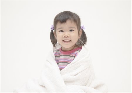A girl in pajama wrapping herself with a bath towel Stock Photo - Premium Royalty-Free, Code: 670-05652510