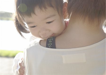Girl in mother's arms Stock Photo - Premium Royalty-Free, Code: 670-05652540