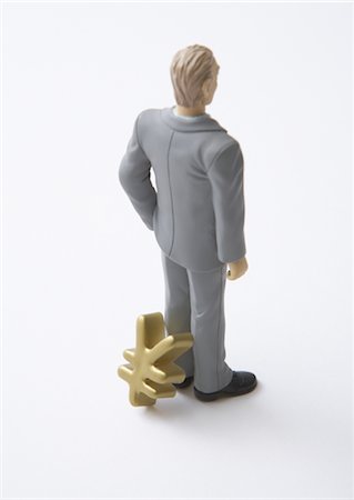 Miniature businessman and yen sign Stock Photo - Premium Royalty-Free, Code: 670-05652954