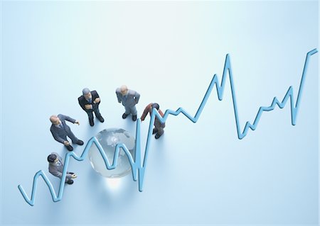 Miniature businessmen surrounding glass globe Stock Photo - Premium Royalty-Free, Code: 670-05854824