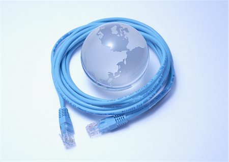 Glass globe surrounded with LAN cable Foto de stock - Sin royalties Premium, Código: 670-05854848