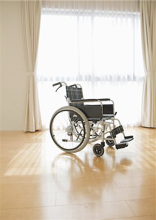 Wheelchair by a window Stock Photo - Premium Royalty-Free, Code: 670-06025067