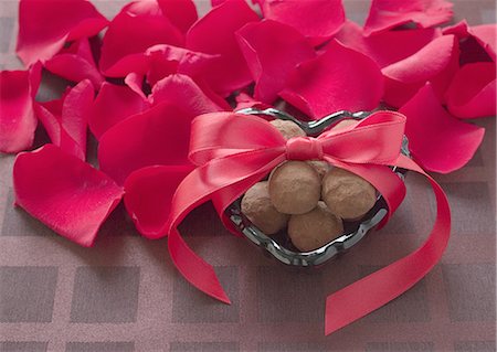 Petals and chocolates tied with ribbon Stock Photo - Premium Royalty-Free, Code: 670-06451016