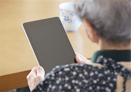 90's woman touching a tablet PC Stock Photo - Premium Royalty-Free, Code: 670-06824781