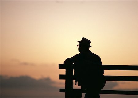 person sitting on bench silhouette