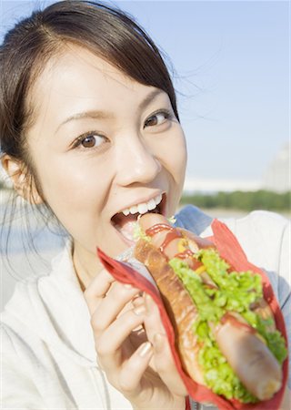 woman eating hot dogs