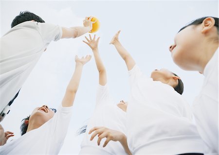 Elementary school students catching a ball Stock Photo - Premium Royalty-Free, Code: 670-02642656