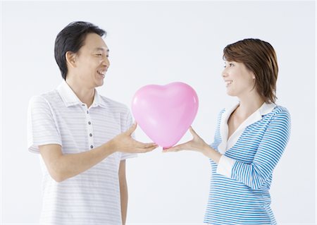 Couple holding heart shape Stock Photo - Premium Royalty-Free, Code: 670-02966696
