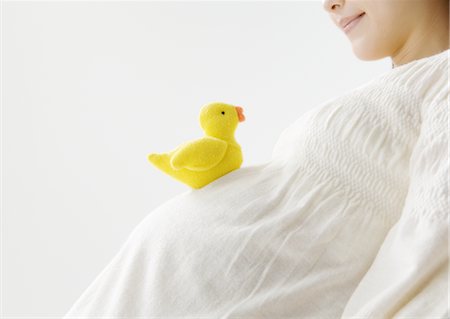 feel - A pregnant woman and stuffed chick Stock Photo - Premium Royalty-Free, Code: 670-02966758