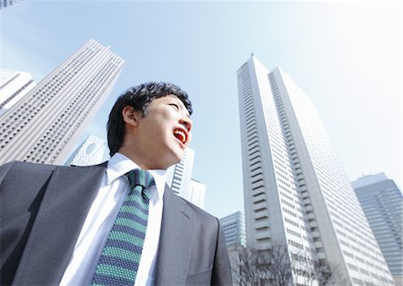 financial district - Businessman looking up Stock Photo - Premium Royalty-Free, Code: 670-03234584