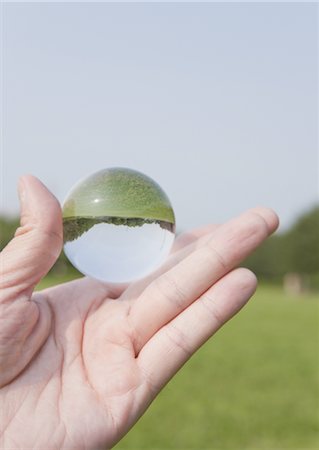 reversed - Close up of hand holding sphere Stock Photo - Premium Royalty-Free, Code: 670-03607556