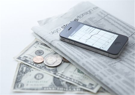 Smartphone, newspaper, and money Stock Photo - Premium Royalty-Free, Code: 670-03709150