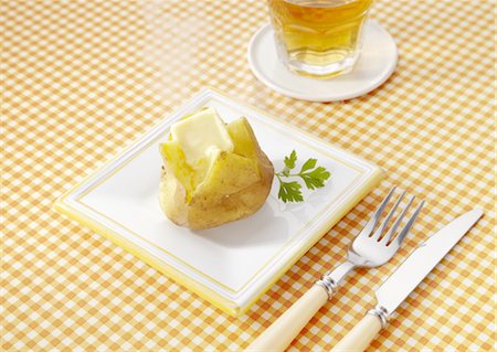 Potates topped with butter Stock Photo - Premium Royalty-Free, Code: 670-03709789