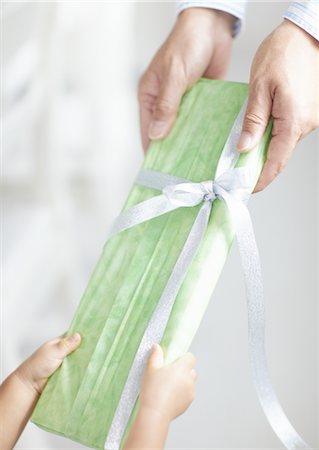 Close up of hands giving a gift Stock Photo - Premium Royalty-Free, Code: 670-03709986