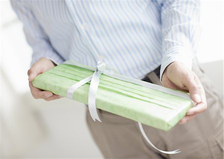 Close up of hands holding a gift Stock Photo - Premium Royalty-Free, Code: 670-03709987
