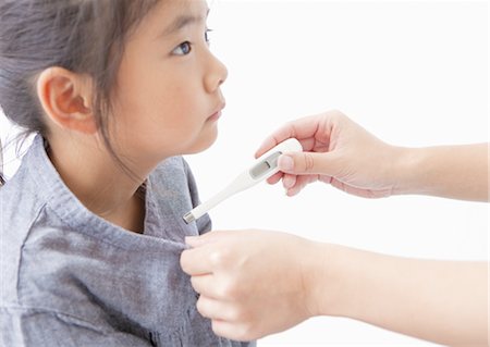 A girl checking her temperature Stock Photo - Premium Royalty-Free, Code: 670-03710176
