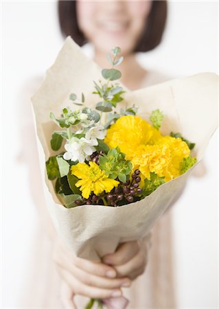 Woman holding flower bouquet Stock Photo - Premium Royalty-Free, Code: 670-03734376