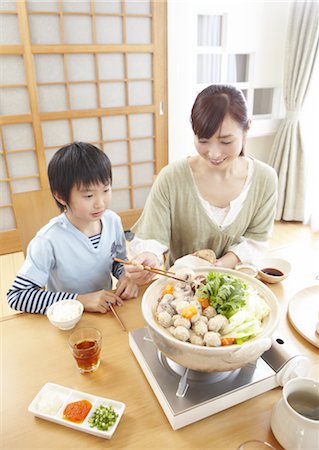 Mother and son sitting around Japanese hot pot Stock Photo - Premium Royalty-Free, Code: 670-03885836