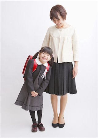 Girl carrying school bag and mother Stock Photo - Premium Royalty-Free, Code: 670-03886157