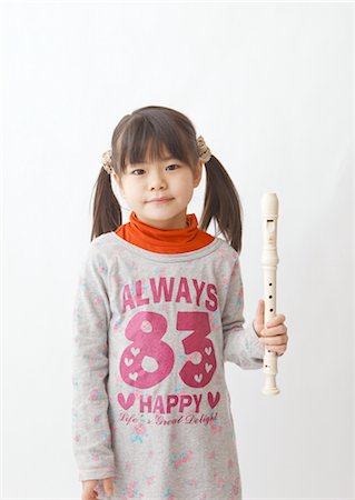 Girl holding recorder Stock Photo - Premium Royalty-Free, Code: 670-03886257