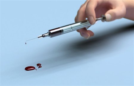 A syringe filled with blood Stock Photo - Premium Royalty-Free, Code: 671-02101943