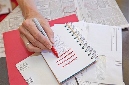 finished - Woman making list in small notebook Stock Photo - Premium Royalty-Free, Code: 673-06025375