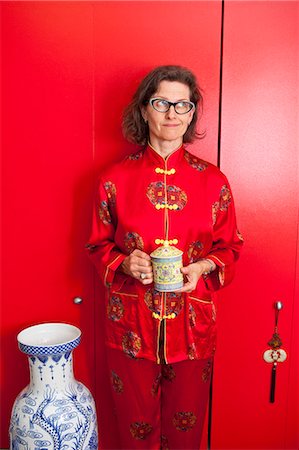 Woman wearing red silk Chinese pajamas Stock Photo - Premium Royalty-Free, Code: 673-06025383