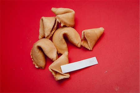 Fortune cookies on red surface Stock Photo - Premium Royalty-Free, Code: 673-06025392