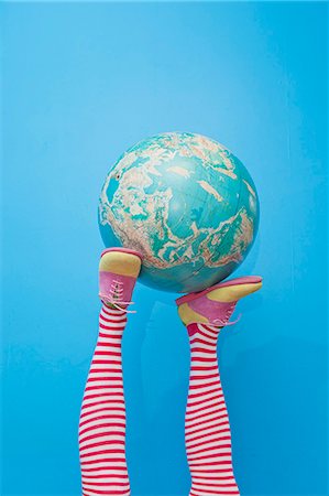 people holding globe - Legs in striped socks with colorful shoes holding globe Stock Photo - Premium Royalty-Free, Code: 673-06025423