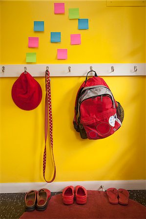 shoe hanging - Yellow wall with colorful post-its and loaded coat hooks Stock Photo - Premium Royalty-Free, Code: 673-06025437