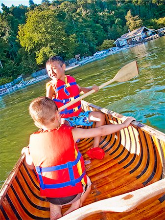 row boat canoe - Two young boys paddling canoe Stock Photo - Premium Royalty-Free, Code: 673-06025446