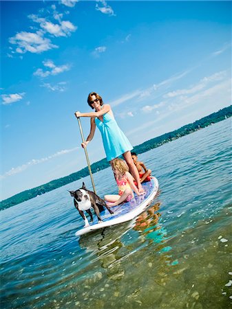 dog look up person - Woman on paddle board with kids and dog Stock Photo - Premium Royalty-Free, Code: 673-06025473