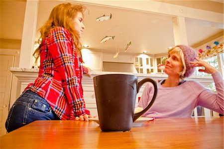 simsearch:614-06898440,k - Woman seated at dining table talking with teen girl Stock Photo - Premium Royalty-Free, Code: 673-06025529