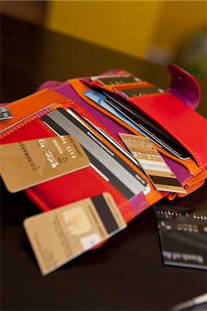 Open colorful wallet with cut up credit cards Stock Photo - Premium Royalty-Free, Code: 673-06025558