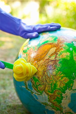 pictures clean environment dirty environment - Woman wearing rubber gloves to scrub globe outdoors Stock Photo - Premium Royalty-Free, Code: 673-06025571