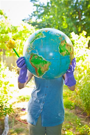 female rubber gloves - Woman wearing rubber gloves and holding globe Stock Photo - Premium Royalty-Free, Code: 673-06025572