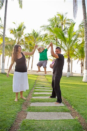 palm path - Woman and man holding baby with young boy outdoors Stock Photo - Premium Royalty-Free, Code: 673-06025607