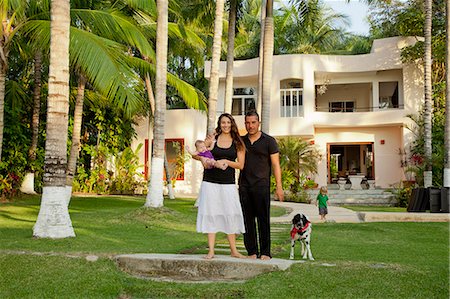 palm path - Portrait of young family in front of large house Stock Photo - Premium Royalty-Free, Code: 673-06025609