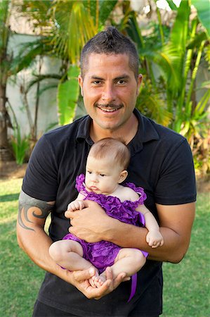 dad with tattoos - Man in black clothing holding baby girl Stock Photo - Premium Royalty-Free, Code: 673-06025601